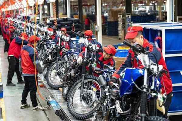 How can the Motorcycle Assembly Line balance new model trial production and regular mass production?